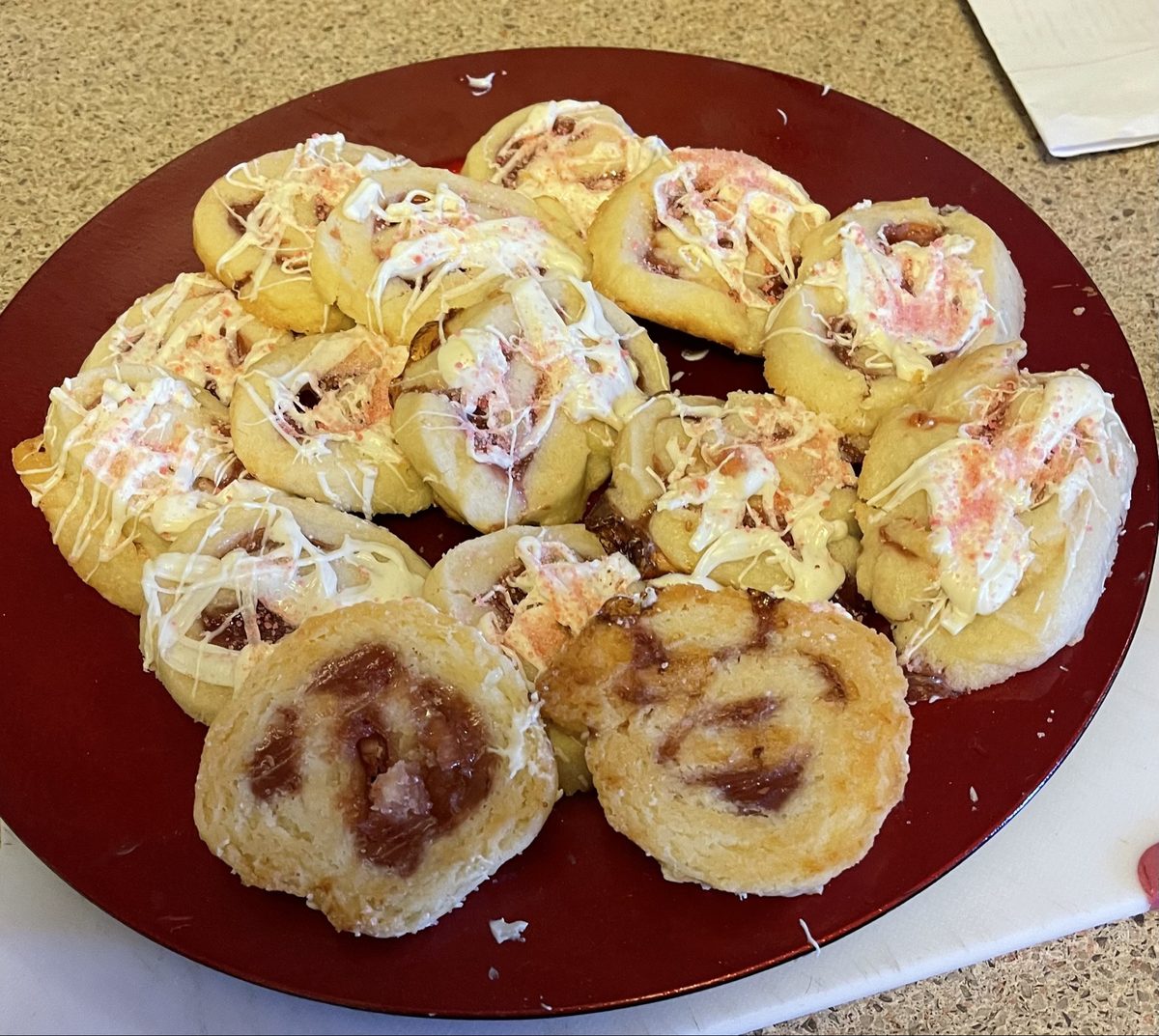 Raspberry swirl cookies on a red plate