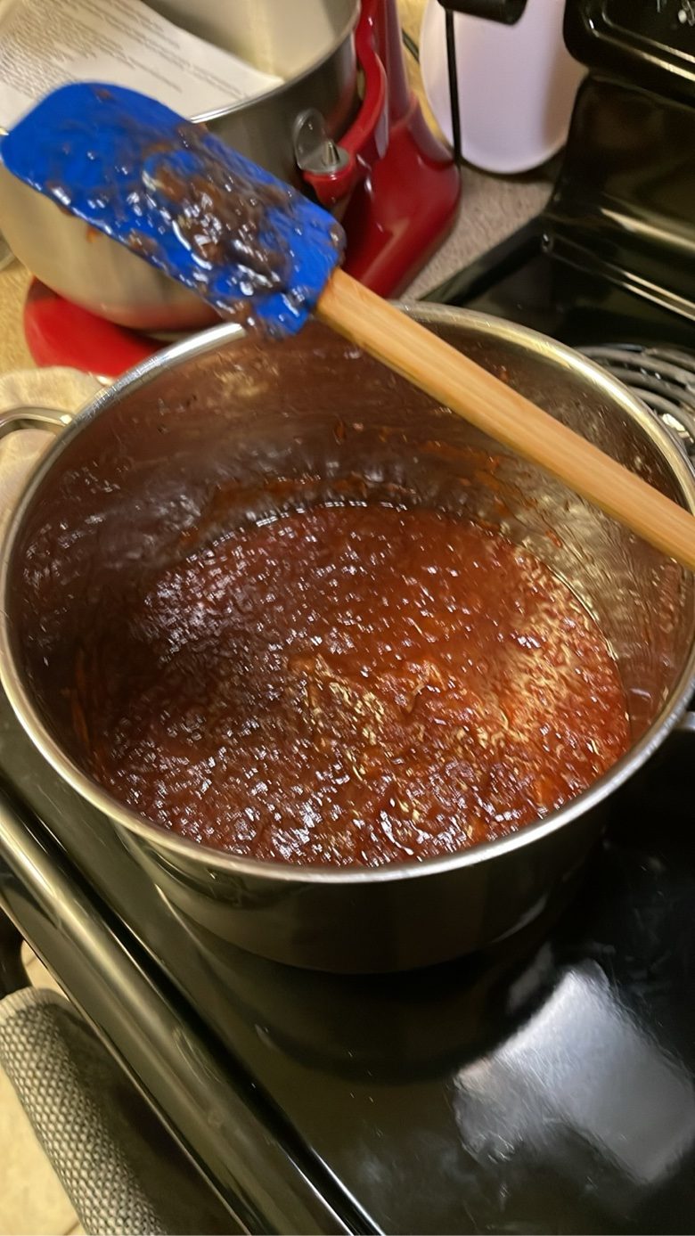 Strawberry-rhubarb-apple jam cooking in a pot